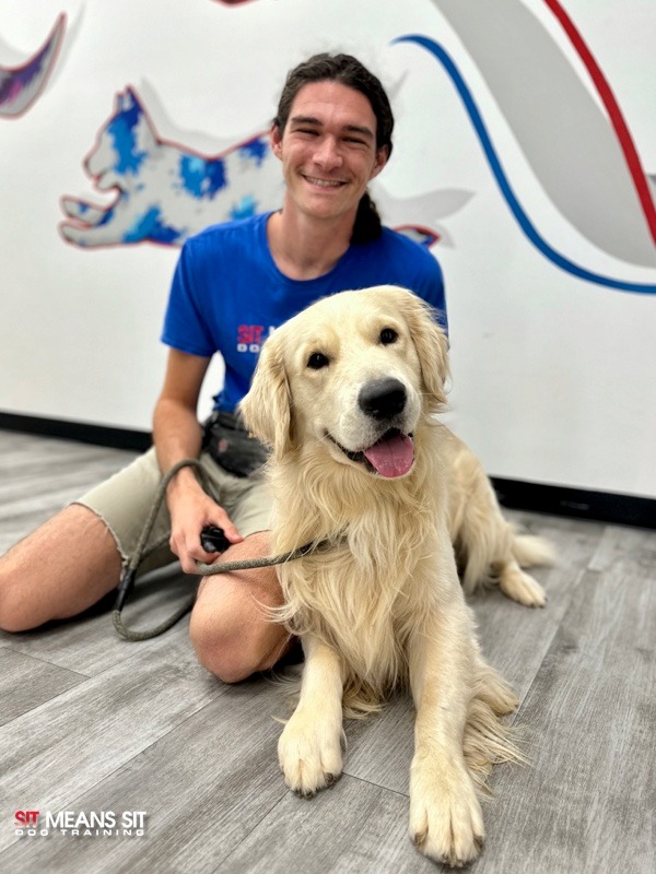 trainer with dog on the floor indoors