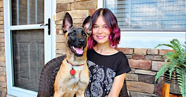 trainer ale sitting with german shepherd dog